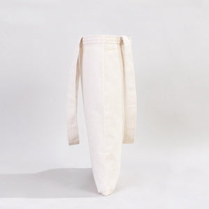 White ceramic vase with a ribbed texture on a light gray background