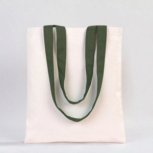 White tote bag with green handles on a light gray background