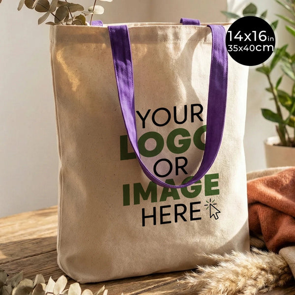 Tote bag beige avec anses violettes sur une surface en bois, personnalisable avec votre logo ou image pour un EVJF chez Pamusan.