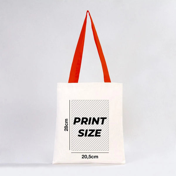 Tote bag blanc avec anses rouges et informations sur les dimensions de l'impression sur fond gris clair chez Pamusan.
