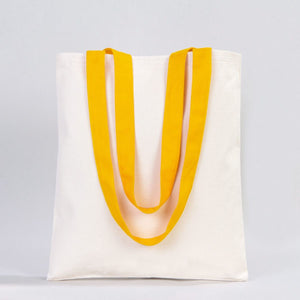 White tote bag with yellow handles on a light gray background