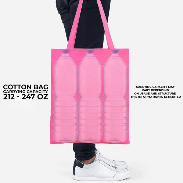 Pink cotton bag with three bottle-shaped compartments held by a person wearing white sneakers.