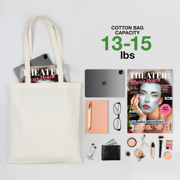 Cotton tote bag with capacity 13-15 lbs, containing a magazine, tablet, and other items on a white background.