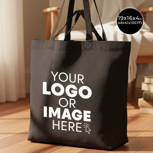 Black tote bag with customizable text on a wooden floor