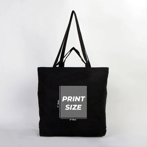 Black tote bag with print size information on a white background