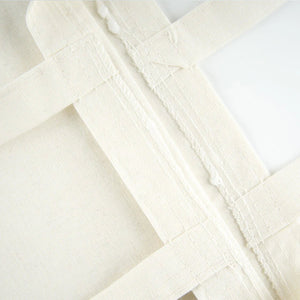 Gros plan sur un tissu en toile de coton écru avec coutures visibles - Pamusan