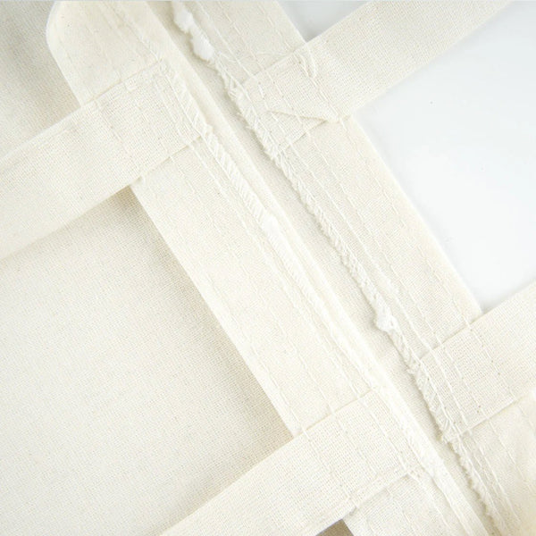 Gros plan sur un tissu en toile de coton écru avec coutures visibles - Pamusan