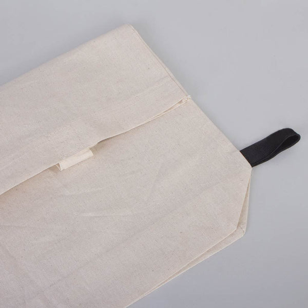 Beige fabric pouch with a black strap on a gray background